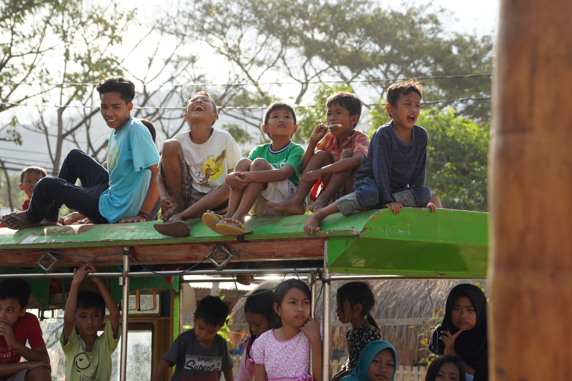 Indonesiske barn på buss på taket.